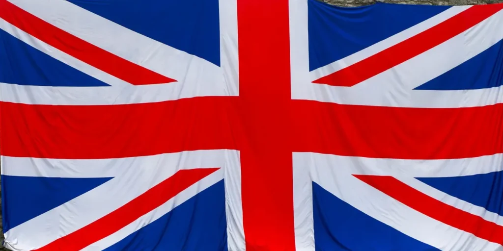 Union Jack flag draped over a historic stone wall, symbolizing British heritage in Rochester, England.