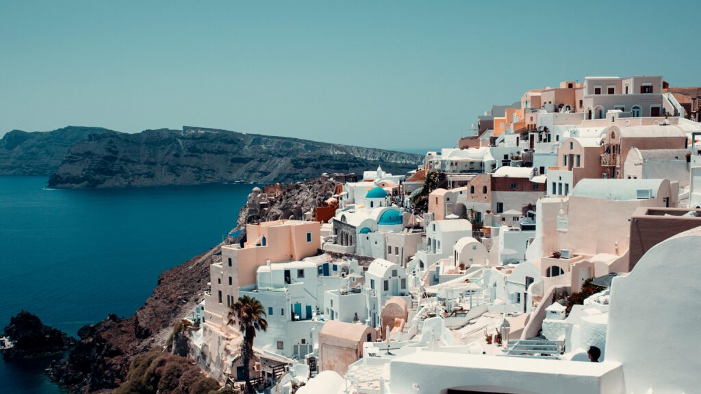 Breathtaking view of iconic white-washed buildings on Santorini's coast.