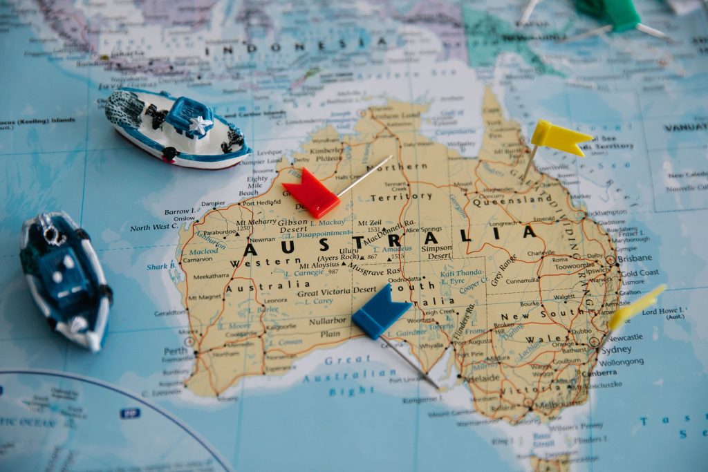 Colorful map of Australia featuring toy ships and pins for navigation.